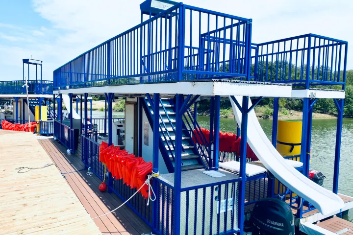 A double-deck Blue Goose party boat with a water slide on Lake Lewisville